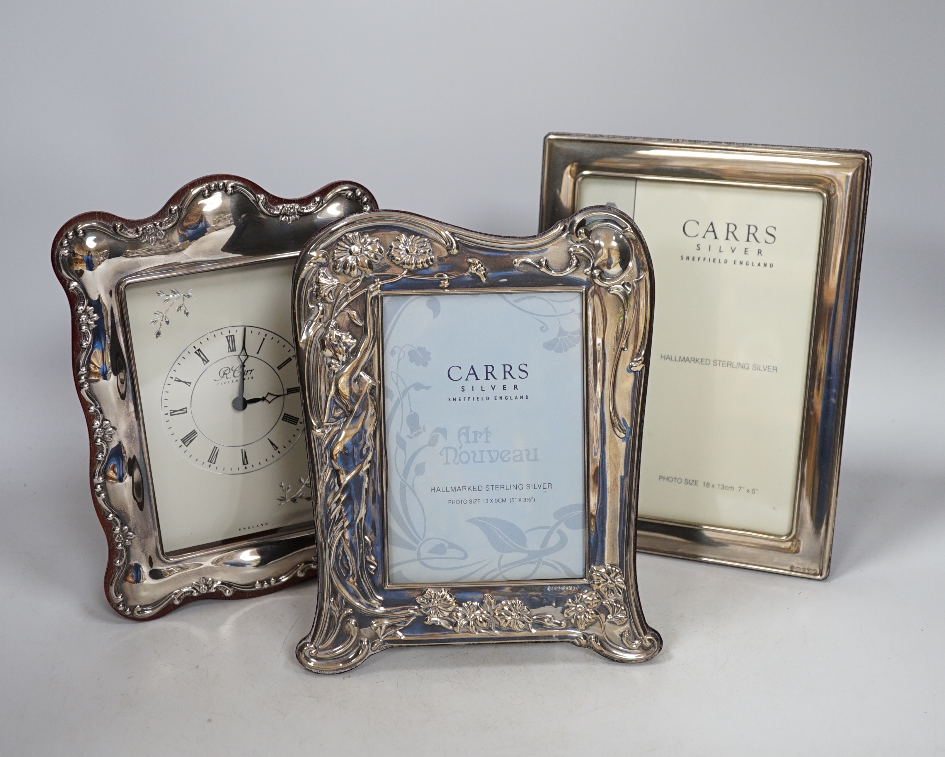 Two modern Carrs silver photograph frames, one of Art Nouveau design, 21cm, and a similar timepiece, 21cm